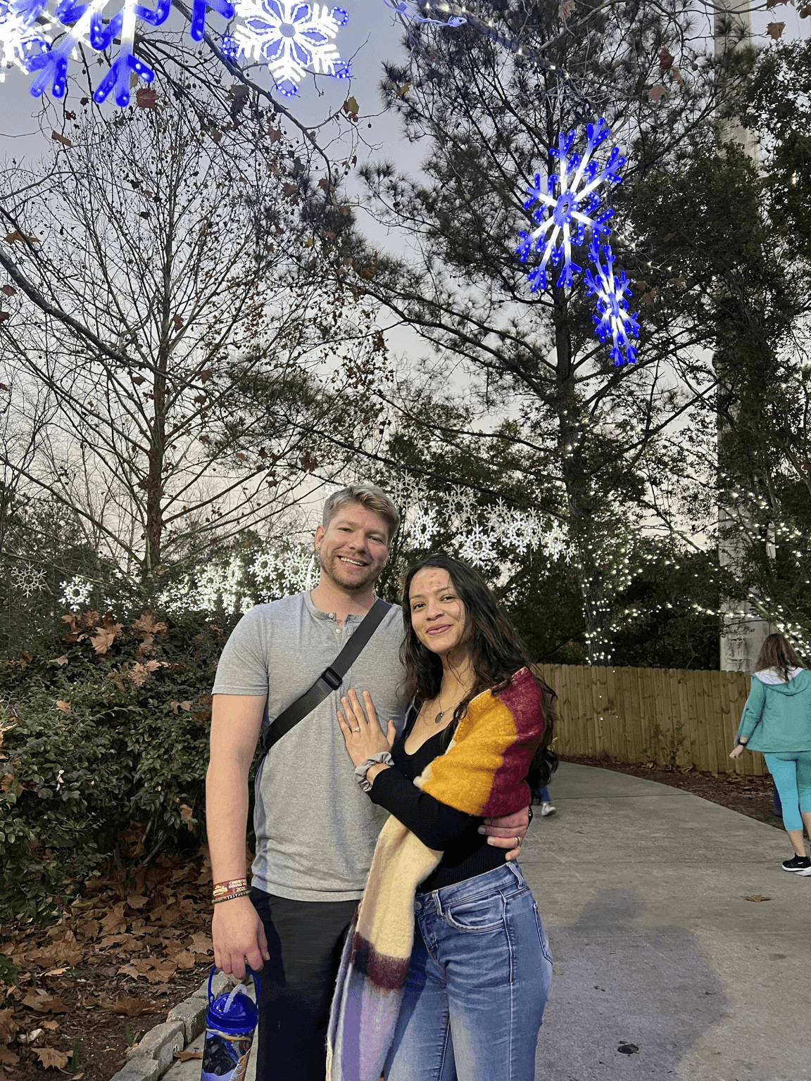 Project Khaleesi founders Dylan and Itzell together beneath holiday lights